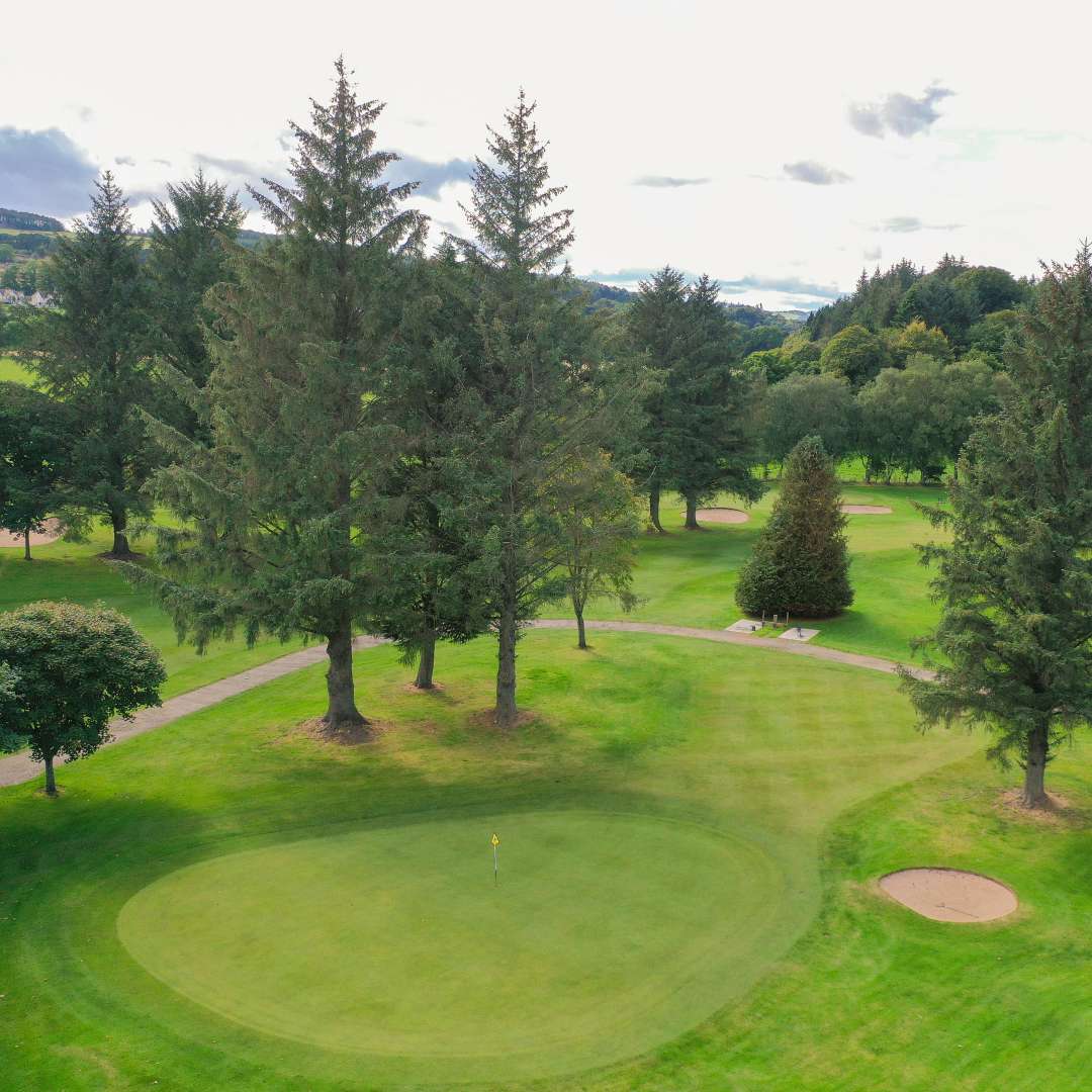 Golf green and bunker on the Blairs 9-hole course at Deeside Golf Club