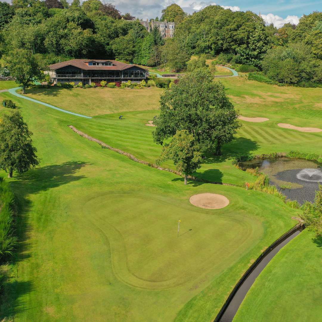 Aerial view of the Blairs course hole 9 with clubhouse, pond and greens at Deeside Golf Club