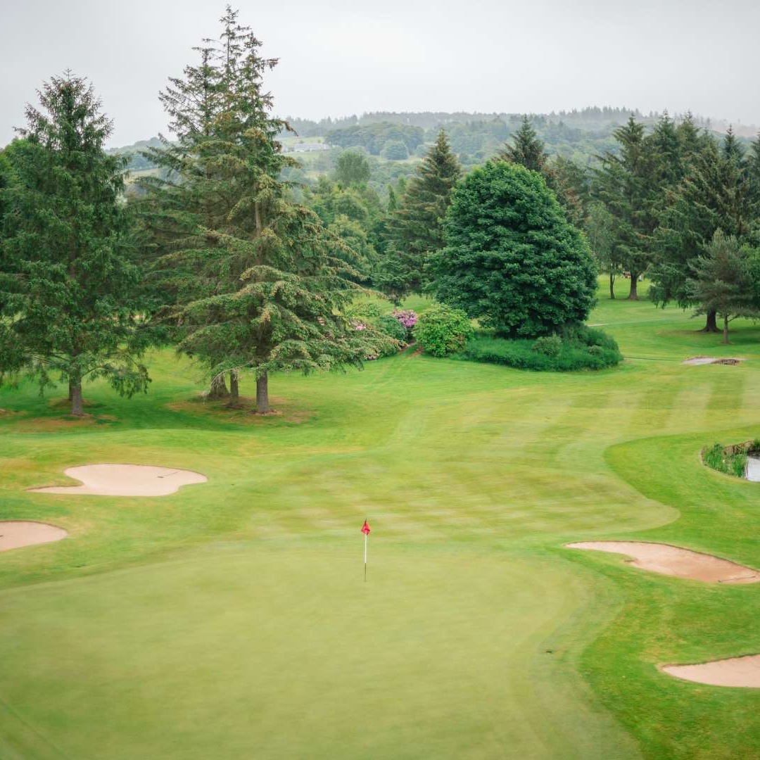 Golf green with surrounding bunkers on the Haughton Course at Deeside Golf Club