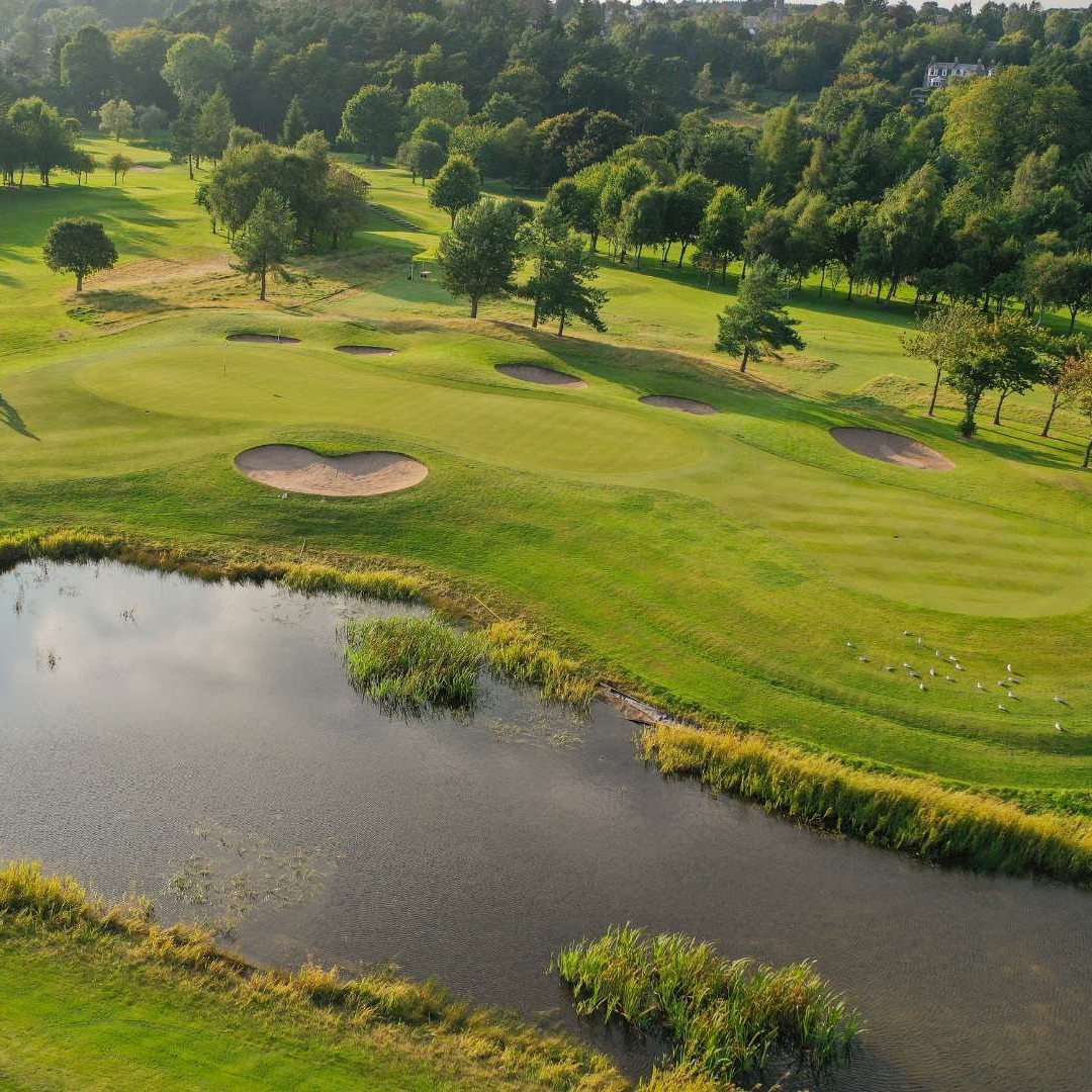 Aerial view of a green, bunkers and pond on the Haughton Course at Deeside Golf Club