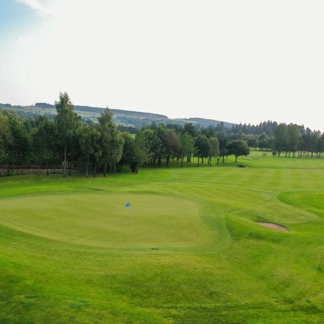 Golf fairway framed by mature trees on the Haughton Course at Deeside Golf Club