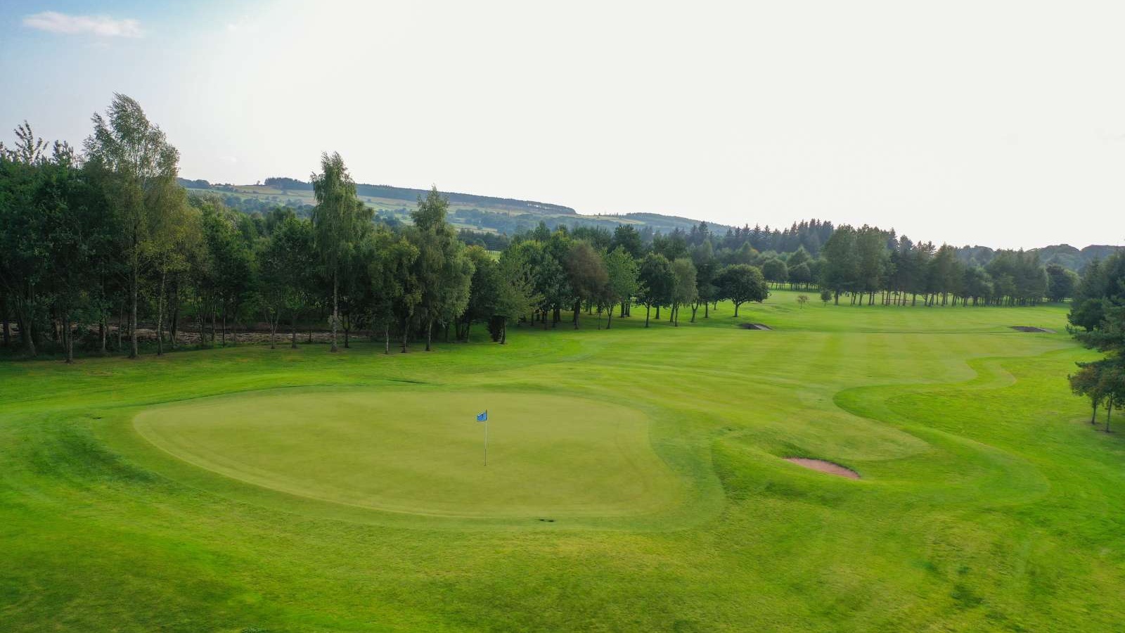 Golf fairway framed by mature trees on the Haughton Course at Deeside Golf Club
